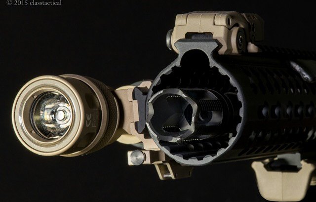 Macro detail photograph of a weapon light and muzzle device
